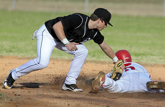 Bauxite Shortstop trying to tag Dyaln Ray as he slides under the tag